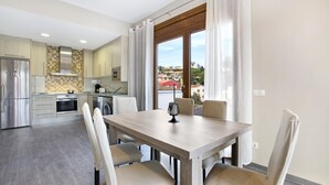 A modern kitchen with a dining area, large windows, and a view of the outside. - Paulina in Lloret de Mar (Lloret de Mar)
