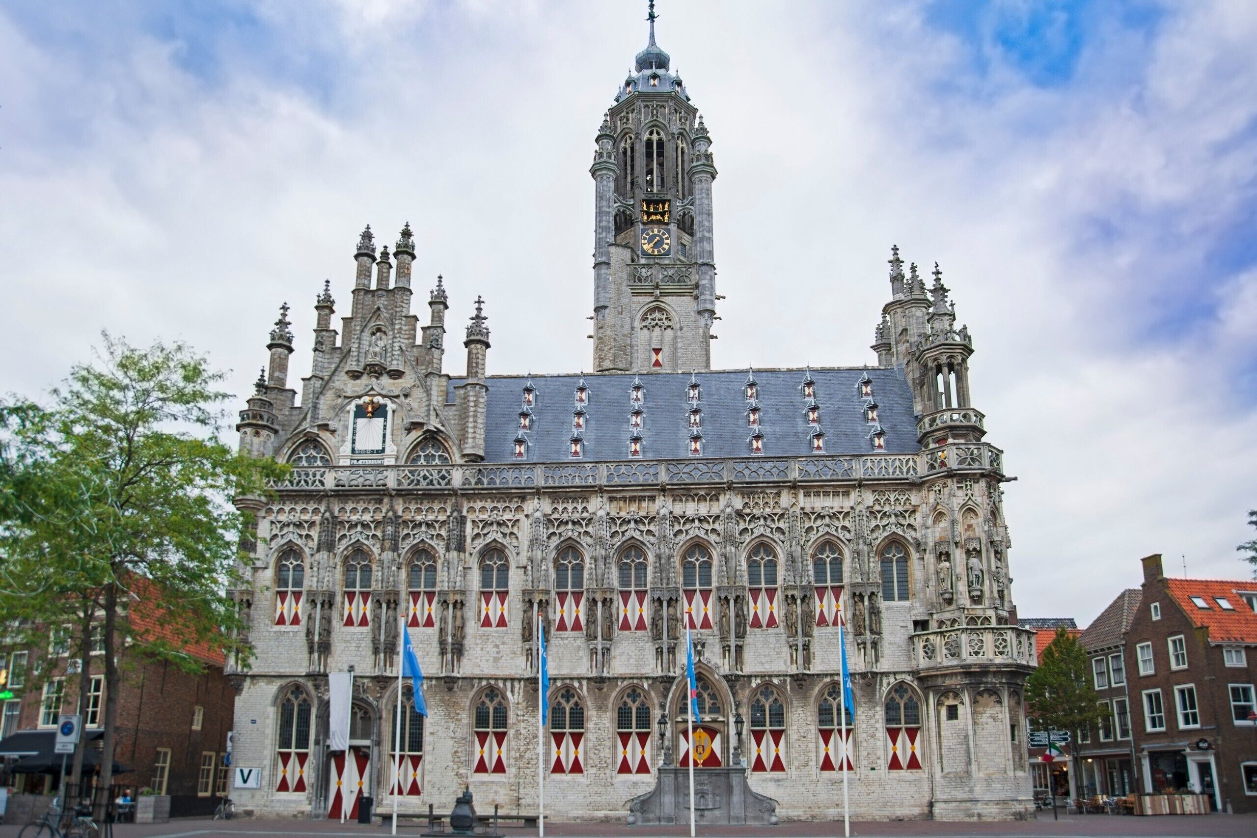 A historic building with a prominent clock tower and intricate architectural details.
