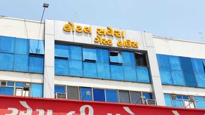 A building with a sign in a local language, possibly Gujarati, indicating a hotel or similar establishment. - HOTEL SAVERA (Ahmedabad)