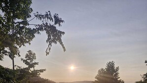 Una piscina all'aperto tranquilla con vista sul tramonto tra gli alberi.