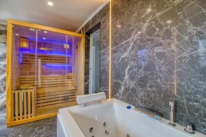 A modern bathroom with a marble wall, a wooden sauna, and a large bathtub. - Appart with Sauna, Jacuzzi, Aromatherapy, 🔥🔥 (Strasbourg)