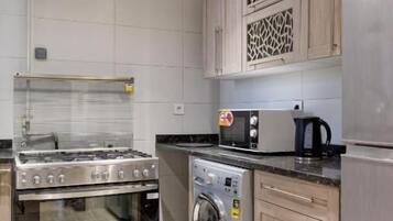 Deluxe Apartment, 2 Bedrooms, City View | Private kitchen | Full-size fridge, oven, stovetop, cookware/dishes/utensils