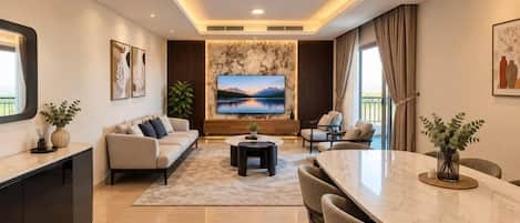 A modern living room with a sofa, TV, dining table, and chairs.