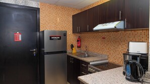 A kitchen with a stainless steel refrigerator, a coffee maker, and a toaster.