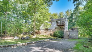 A two-story house with a balcony, surrounded by a wooden fence and trees. - 1/2 Mi to Ogunquit Beach: Maine Home w/ Deck! (Ogunquit)