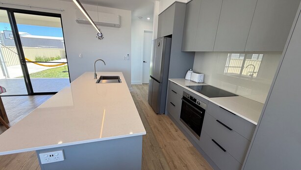A modern kitchen with a central island, built-in appliances, and a view to the outside. - Zion on Yorkes-2 bedroom downstairs unit - Off peak special! (Edithburgh)