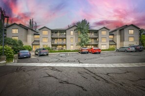 A multi-story residential building with a parking lot in front. - River Pines A303 3 Bedroom Condo (Edwards)