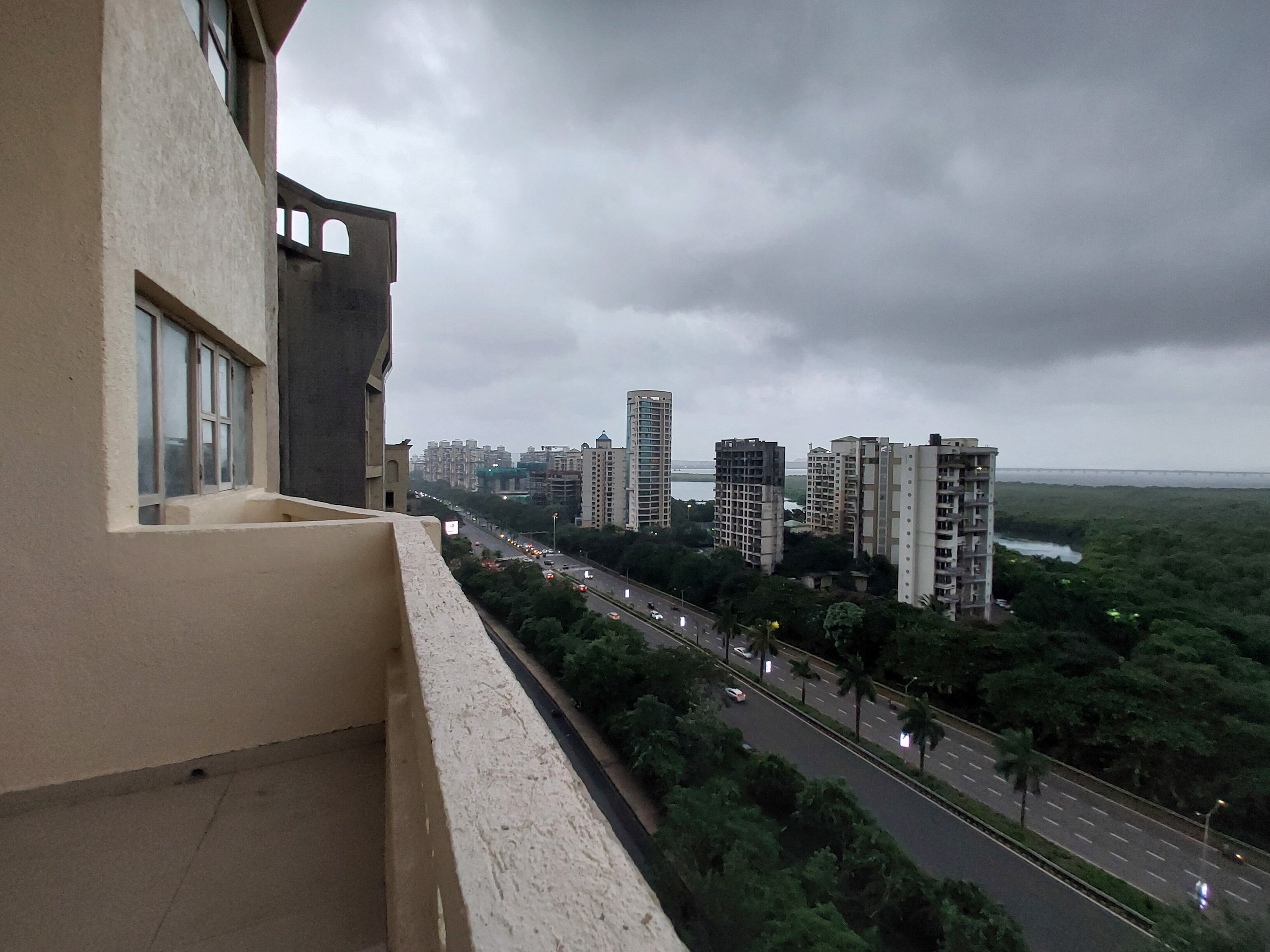 A high-rise building with a view of a cityscape and a river.