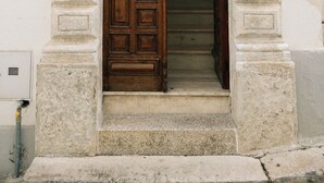 A wooden door with a stone archway, leading to a staircase. - Casalta by Wonderful Italy (Ostuni)