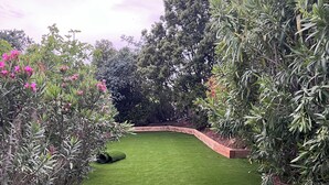 A well-maintained garden with a curved pathway and lush green grass.