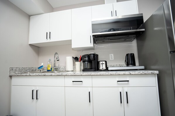 Fridge, microwave, stovetop, coffee/tea maker