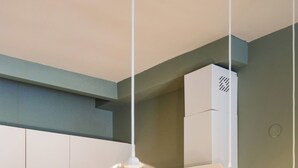 A modern kitchen with wooden countertops, a built-in oven, and a coffee maker. - Mandarin apartments by halu! (Thessaloniki)