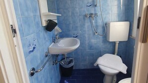 A bathroom with blue tiles, a white sink, a toilet, and a shower. - HOTEL YOUNG PEOPLE UNDER 40 (Rimini)