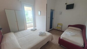 A room with two beds, a TV, and a balcony. - HOTEL YOUNG PEOPLE UNDER 40 (Rimini)