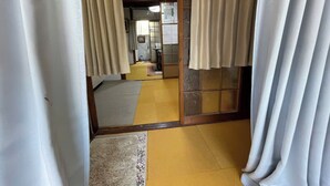 Une pièce de style japonais traditionnel, avec un sol recouvert de tatamis, des portes coulissantes et un paravent shoji.