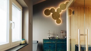 A modern kitchen with a dark floor, a teal cabinet, and a skylight above. - The Kepos Hotel Erlangen (Erlangen)