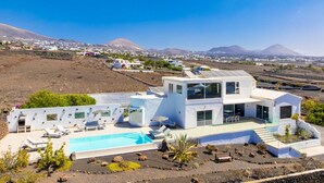 A modern white villa with a pool, surrounded by a rocky landscape and mountains in the background. - The View - Four Bedroom Villa, Sleeps 8 (Tías)