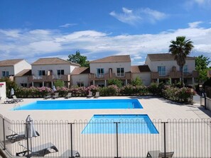 Un hôtel comprenant plusieurs bâtiments, une piscine et des espaces de détente en plein air.