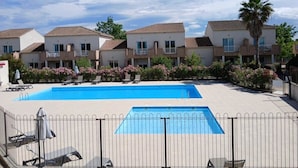Un hôtel comprenant plusieurs bâtiments, une piscine et des espaces de détente en plein air.