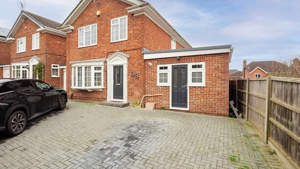 A two-story brick house with a driveway and a car parked in front. - Relaxing Annexe | With Garden Access & Parking (Kent)