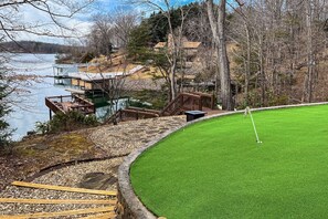 Enjoy a serene golf course setting with a well-maintained putting green and views of the surrounding landscape.