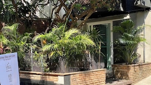 A homey stay and cafe area with a sign indicating amenities like a home stay, coffee, food, and friends. - homey stay and cafe by hematoa (Bangkok)