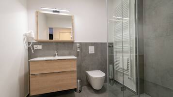 Een douche, een haardroger, handdoeken, toiletpapier