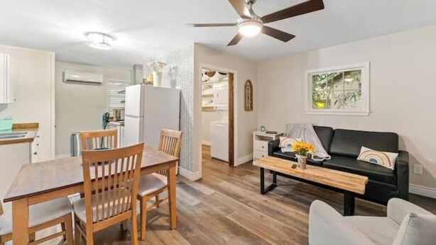 A compact living space with a dining area, a sofa, and a ceiling fan. - Charming Midtown Home w/ Private Patio; Mardi Gras (AL)