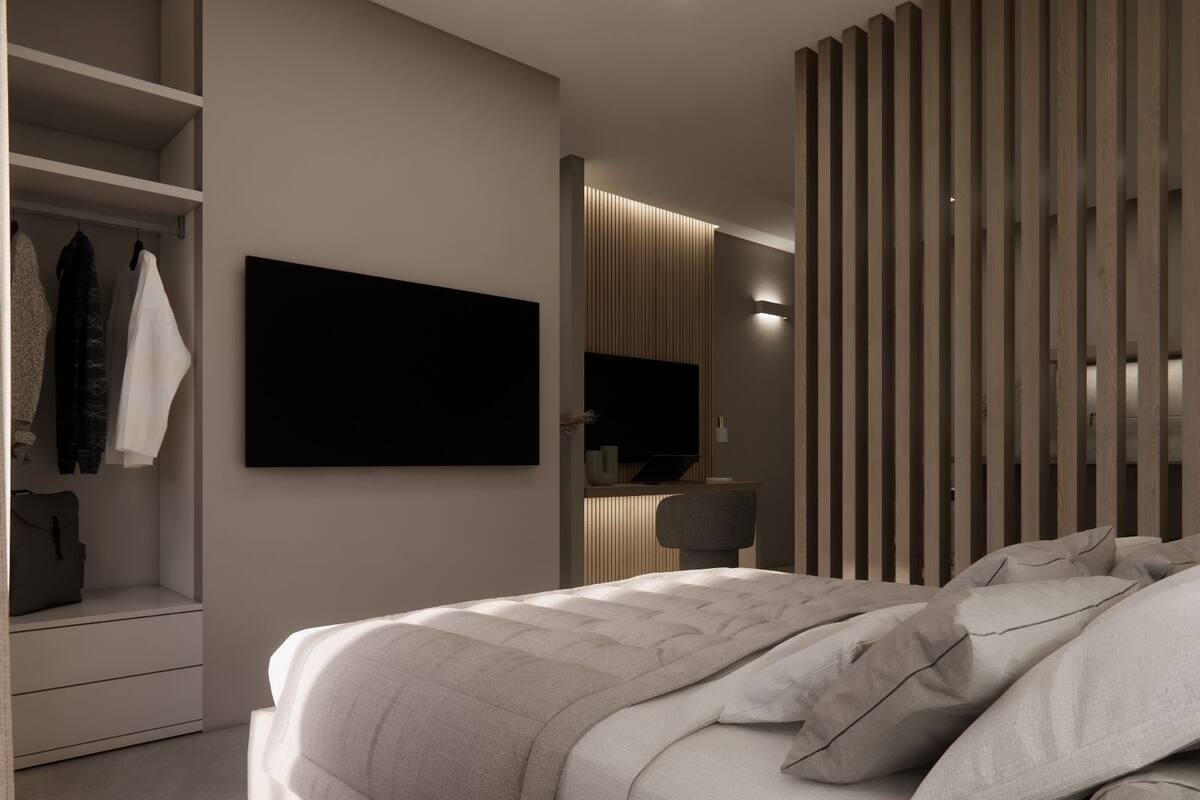 Ein modernes Schlafzimmer mit großem Bett, Einbauschrank und Flachbildfernseher.
