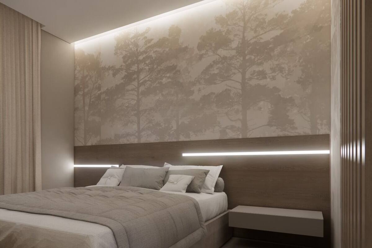 Ein modernes Schlafzimmer mit einem großen Bett, einem Nachttisch und einer Wandleuchte.