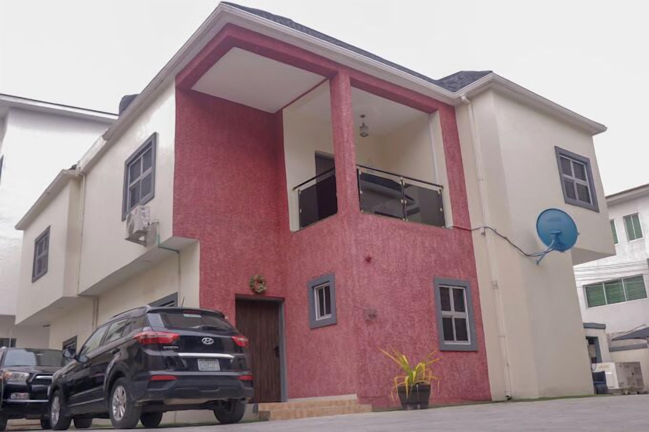 A two-story building with a balcony on the upper floor.