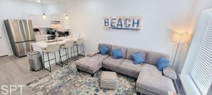 Townhome, Multiple Beds, Kitchen, Garden View (Villas de Laguna 1) | Living area | 75-inch flat-screen TV with digital channels - Villas de Laguna 1 (South Padre Island)
