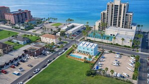 An aerial view of a coastal area with buildings, roads, and a beach. - 2 Levels - New Townhome -heated Pool - #1 (South Padre Island)