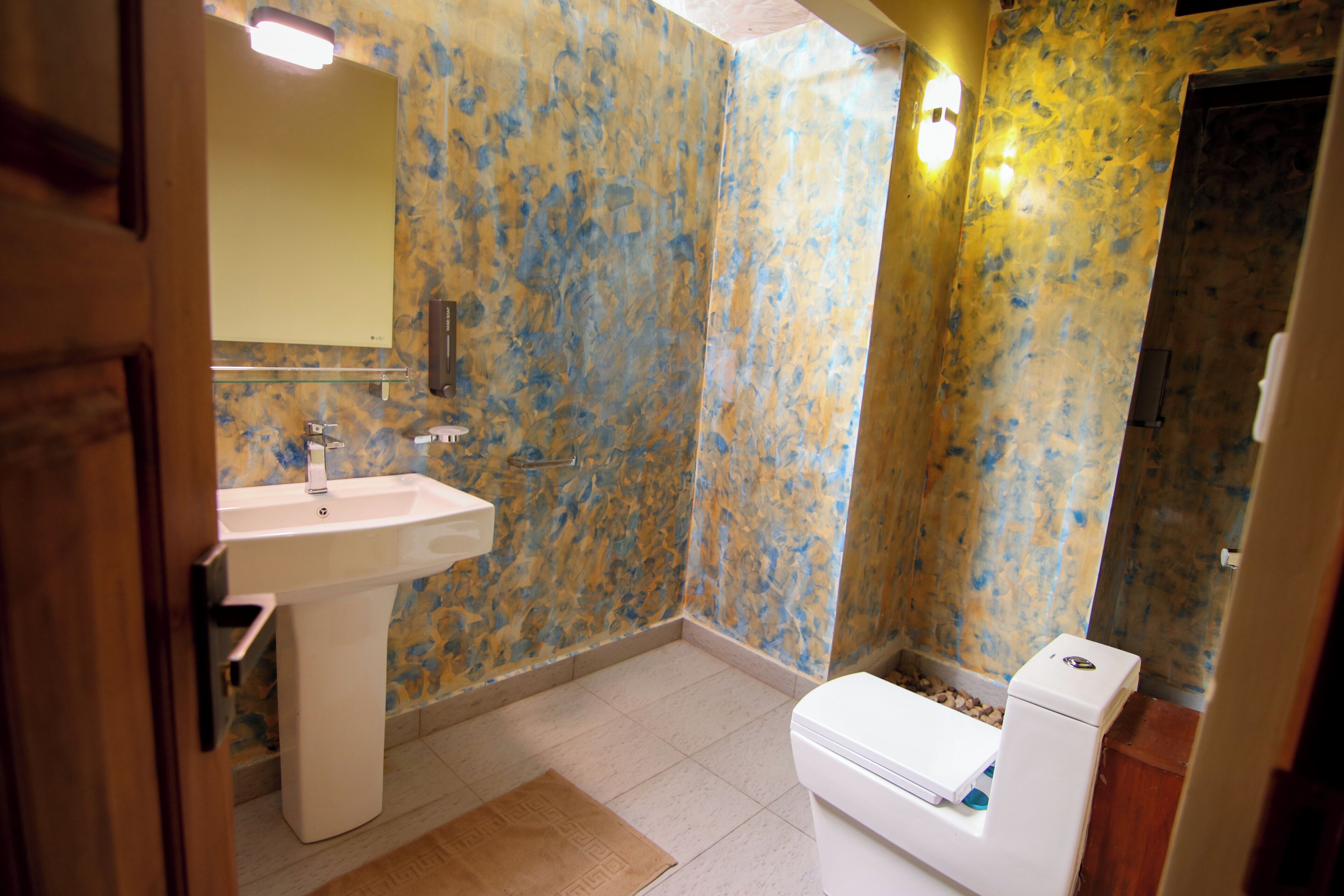 A bathroom with a sink, toilet, and shower.