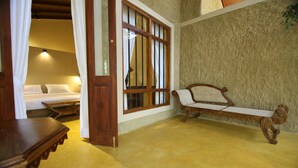 A room with a bed, a bench, and a wooden door. - Cloud Nine Lanka Resort Wilpattu (Wilpattu)