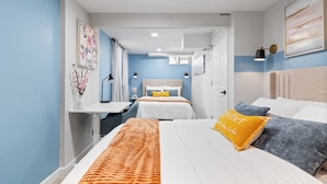 A modern hotel room with two beds, a desk, and a view of the city. - Game Room Retreat with Firepit + Gym + Sleeps 12 (Indianapolis)