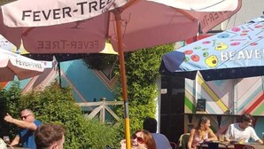 Outdoor seating with tables and chairs, umbrellas, and a building in the background. - The Brookmill (London)