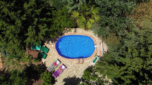 Sheltered house in the mountains with sea views and private pool.
