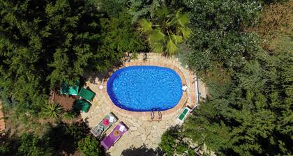 Sheltered house in the mountains with sea views and private pool.