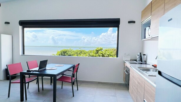 A modern kitchen with a large window overlooking a scenic view.