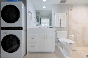 Shower, hair dryer, towels, shampoo