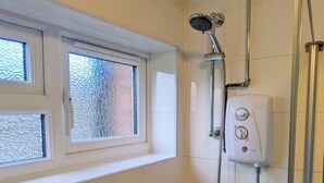 A bathroom with a shower, a window, and a wall-mounted control panel. - Theatre Severn Town House, Parking & Quarry Views (Shropshire)