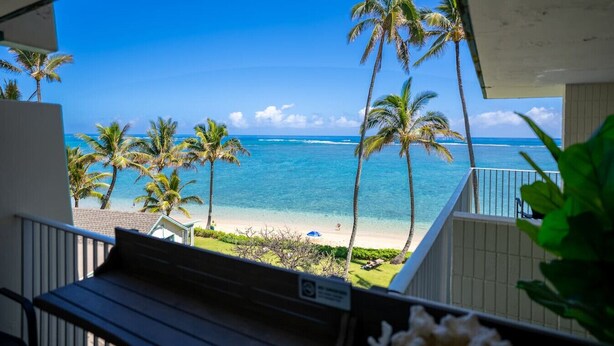 A balcony with a view of a beach and ocean. - Oceanfront Hauula 1BR Condo I Beach, Pool, Parking (Hauula)
