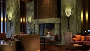 A lobby with stone columns, a fireplace, and seating arrangements. - InterContinental ALPENSIA PYEONGCHANG RESORT by IHG (Pyeongchang-gun)