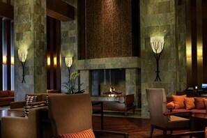 A lobby with stone columns, a fireplace, and seating arrangements. - InterContinental Hotels ALPENSIA PYEONGCHANG RESORT by IHG (Pyeongchang-gun)