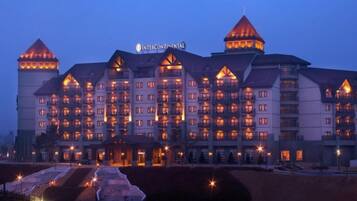 A multi-story hotel with a distinctive architectural style, featuring a central tower and multiple balconies.