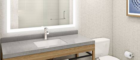 A modern bathroom with a large mirror, a wooden vanity, a toilet, and a framed artwork on the wall.