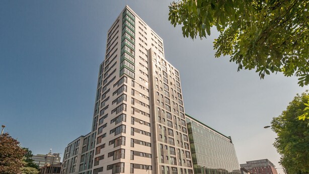A modern high-rise building with a glass facade and multiple floors. - Argyle Street - Apartment 2 (Glasgow)