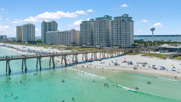 A coastal hotel with multiple high-rise buildings, a beach, and a pier. - Inn At Summerwind 501 - This Is It (Navarre)