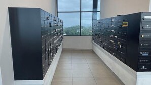 A room with two rows of black filing cabinets against the wall, a large window with a view of buildings, and a tiled floor. - JQ#11 City View Slide LoftBed 2R1B 5Pax Near Suria Mall, Gaya St, Sicc (Kota Kinabalu)